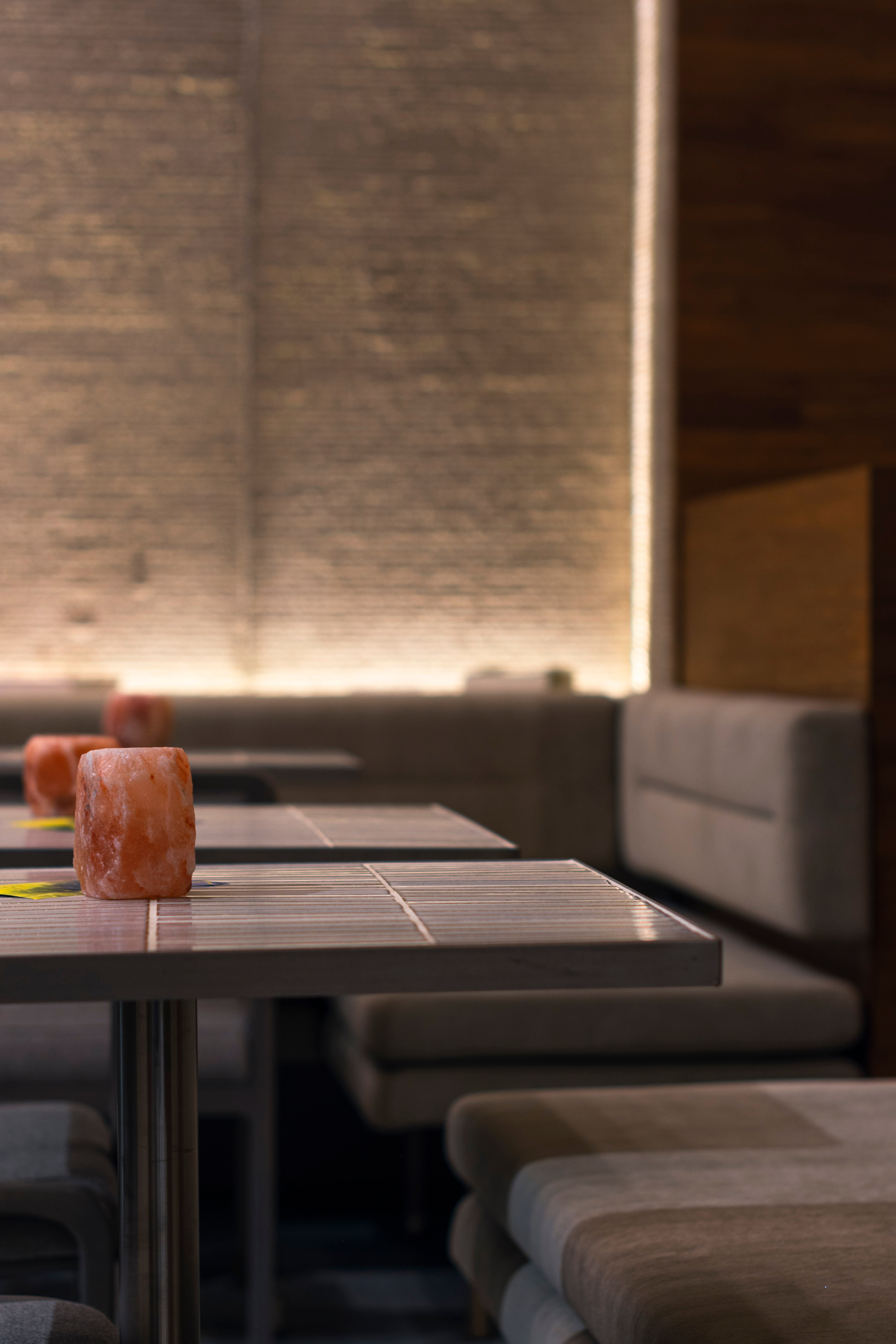 Dining area at NEXT Amsterdam with a softly lit Biyusai Border White wall.