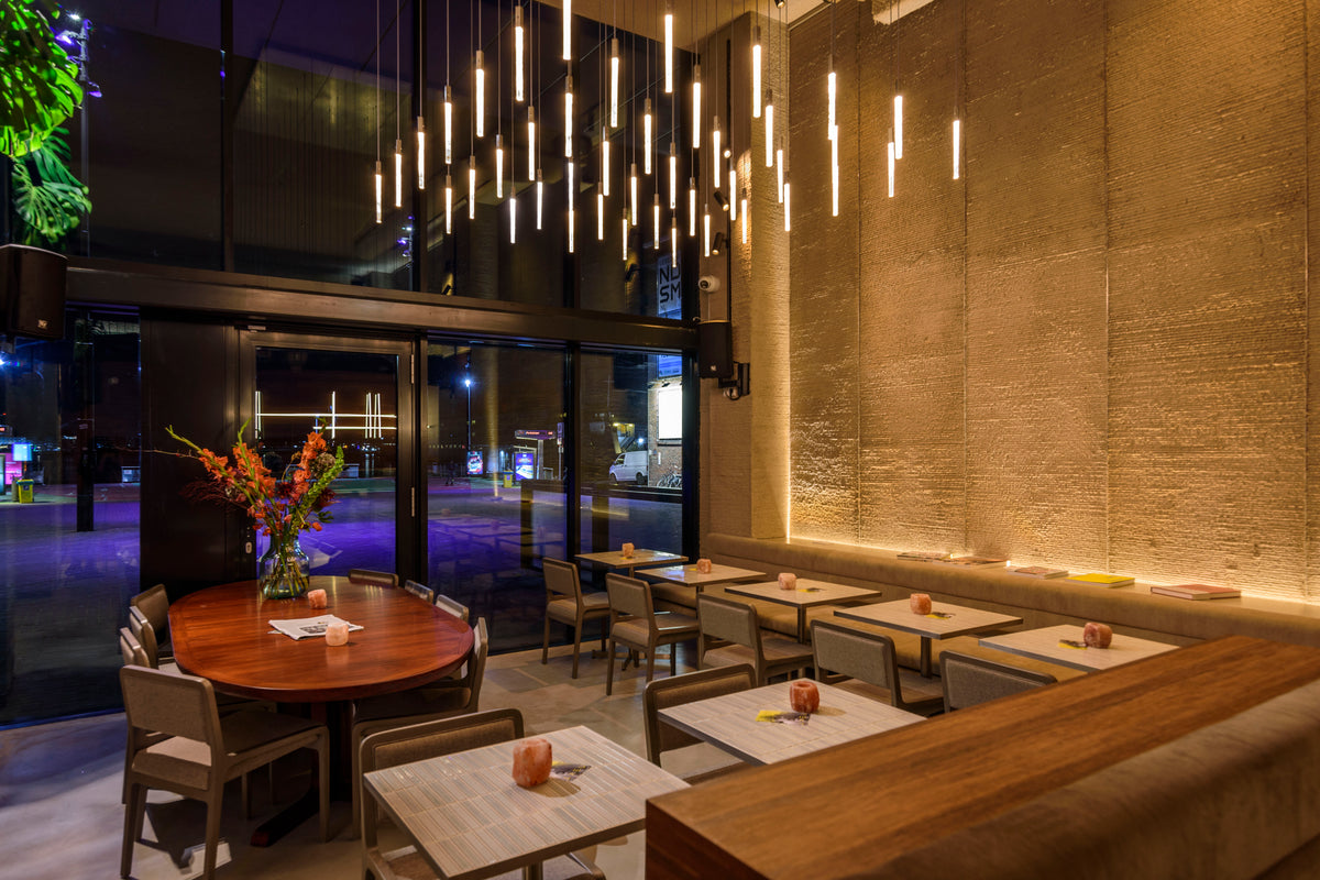 Biyusai Border White forming a tall textured wall in the NEXT Amsterdam dining room.