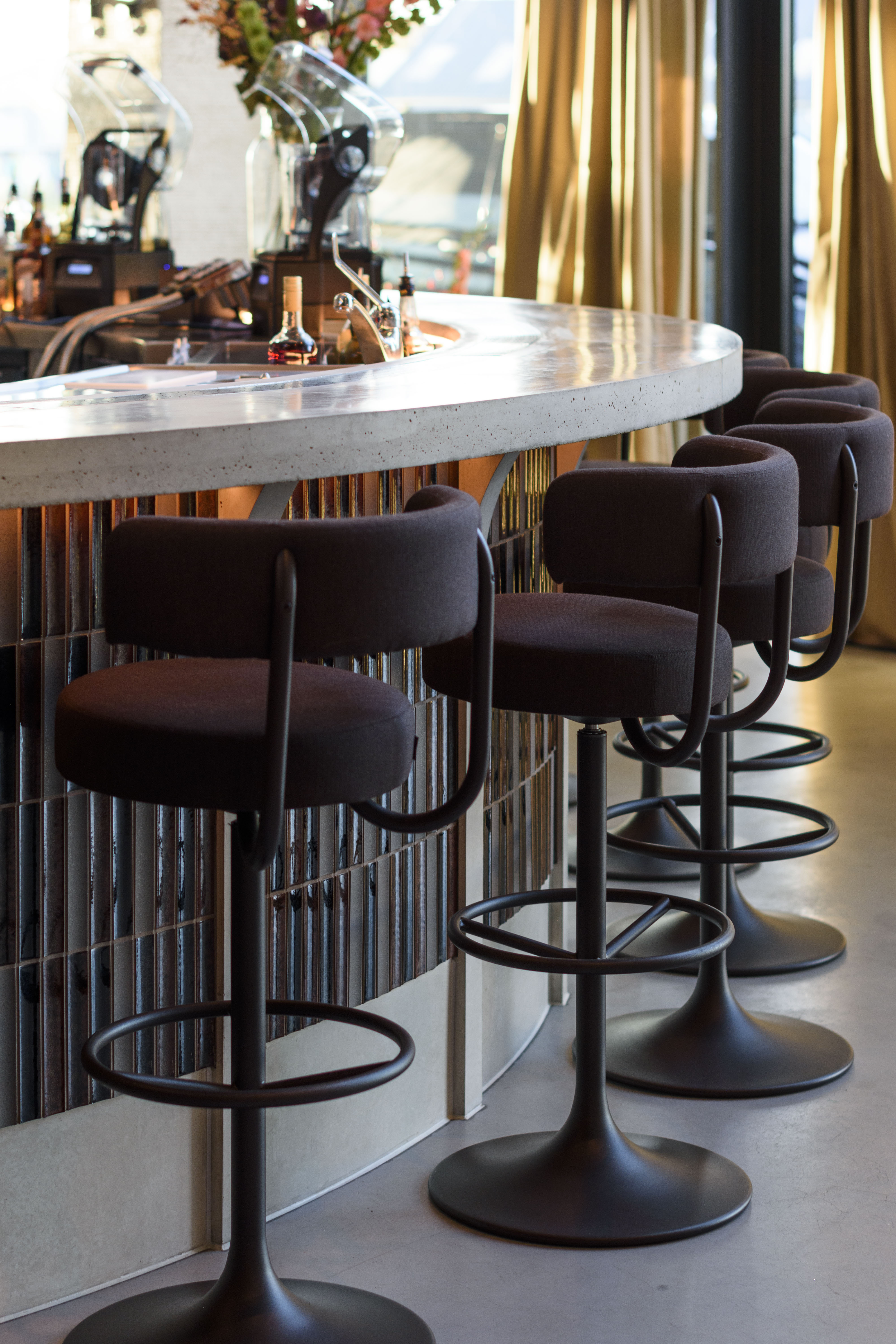 Sairin Brown Mix tile detail across the curved bar front at NEXT Amsterdam.