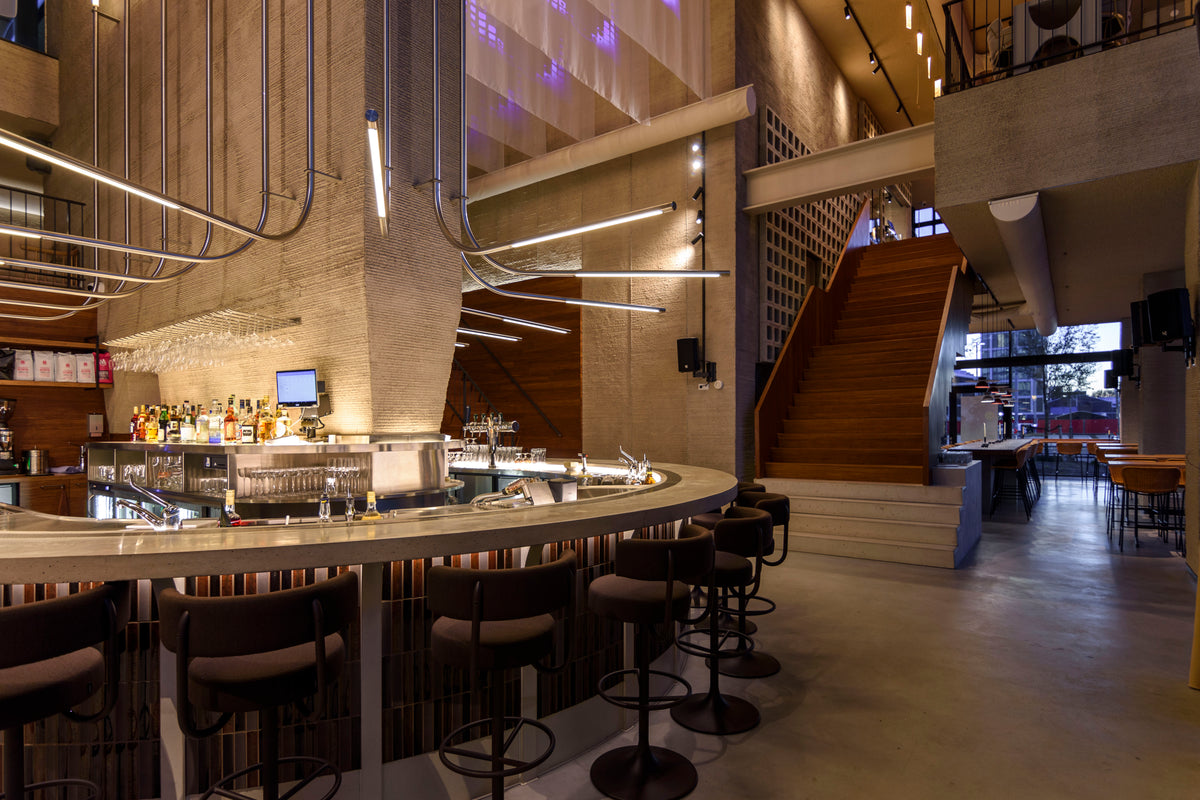 NEXT Amsterdam bar and stair with vertically laid Sairin Brown Mix tiles.