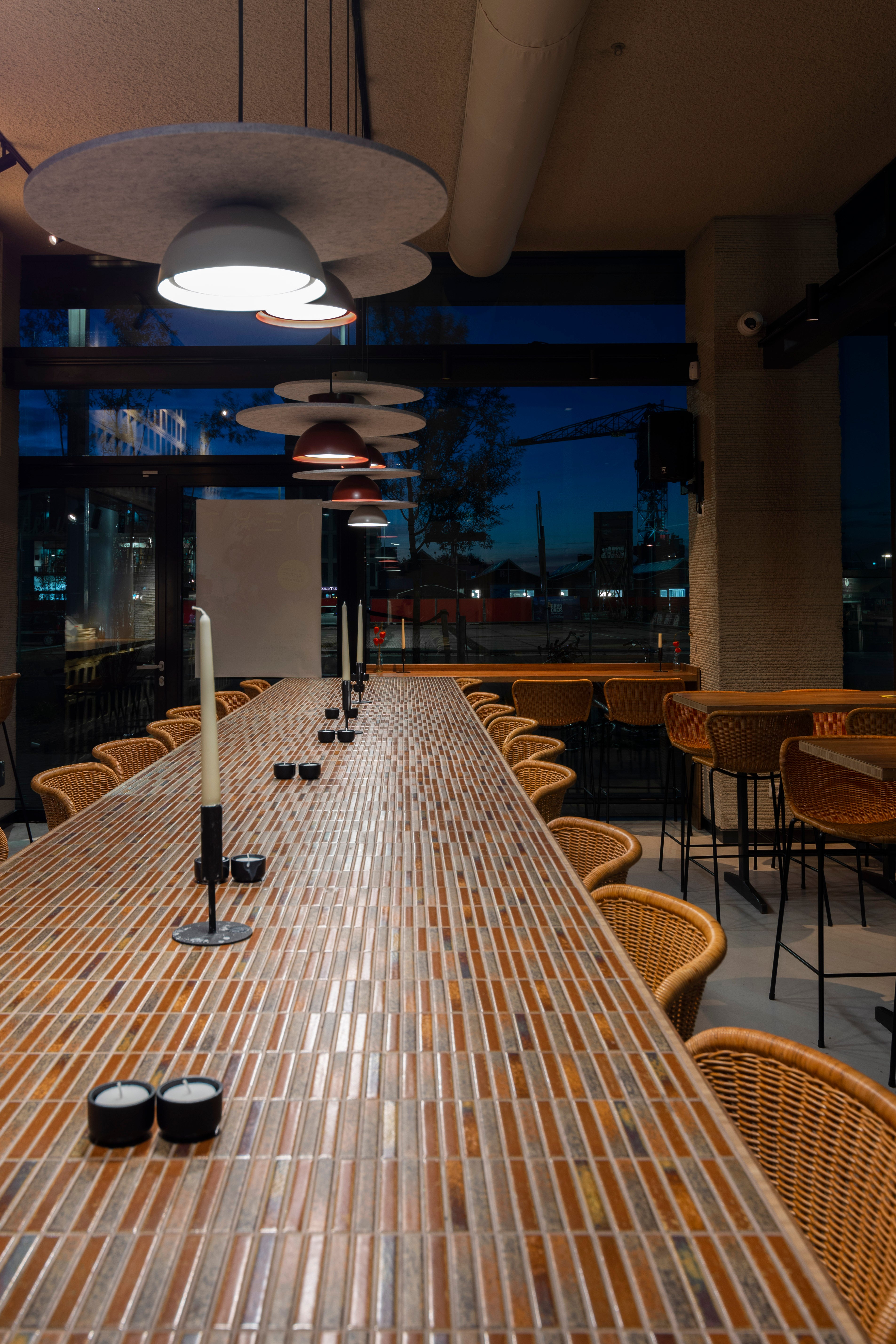 Long communal table at NEXT Amsterdam finished with Yohen Brown Mix tiles.