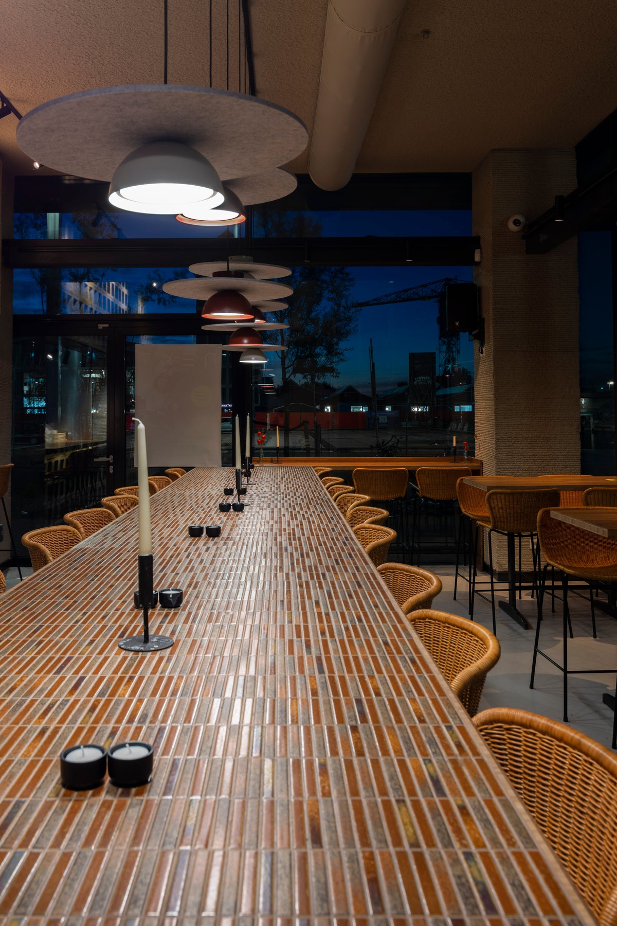 Long communal table at NEXT Amsterdam finished with Yohen Brown Mix tiles.