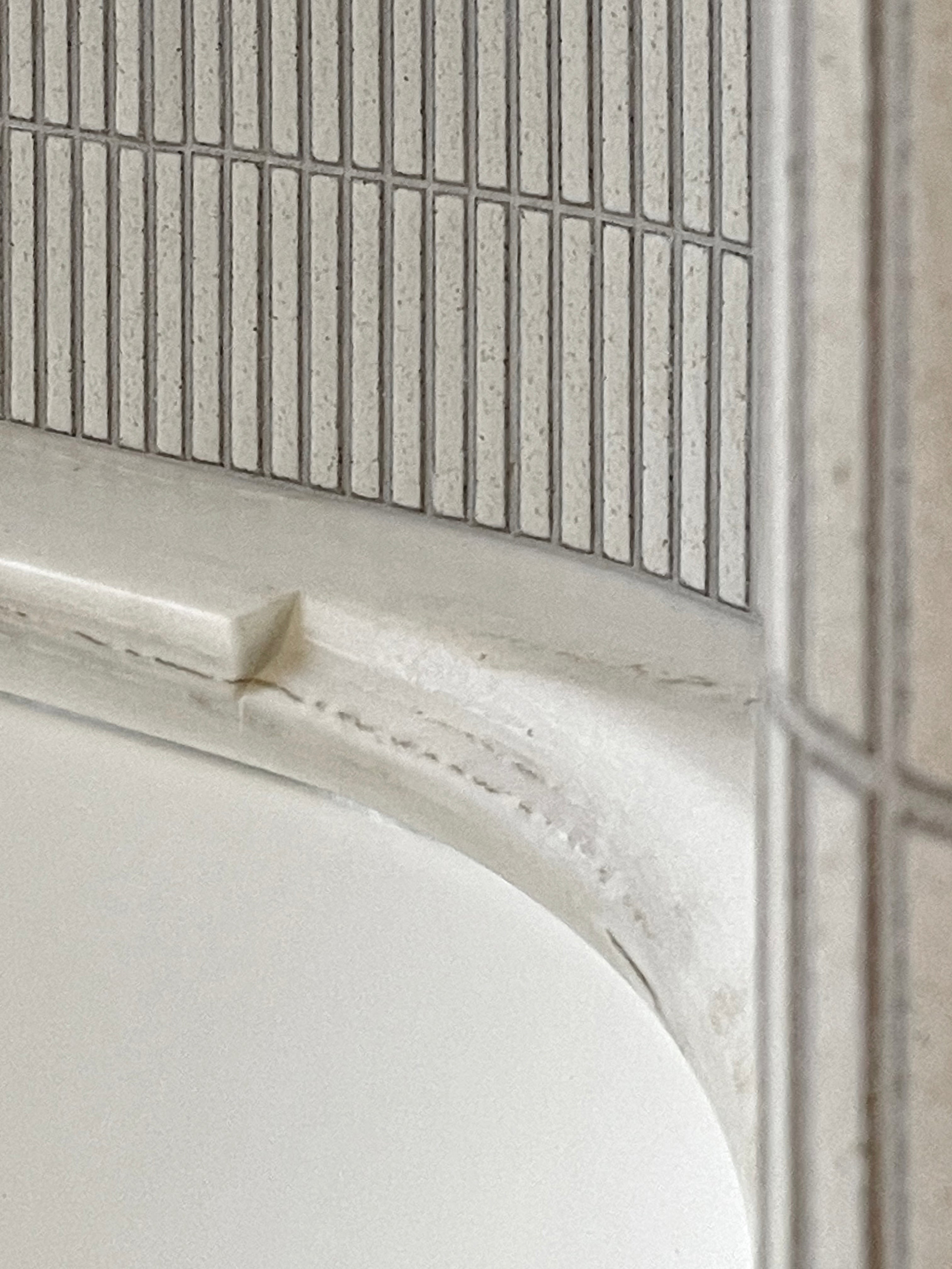 Precise junction between pale stone and Yohen Speckled White Japanese tile.