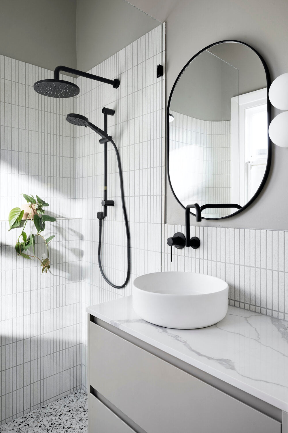 Kaji Border Powder White across the shower and basin walls at Cecil Street