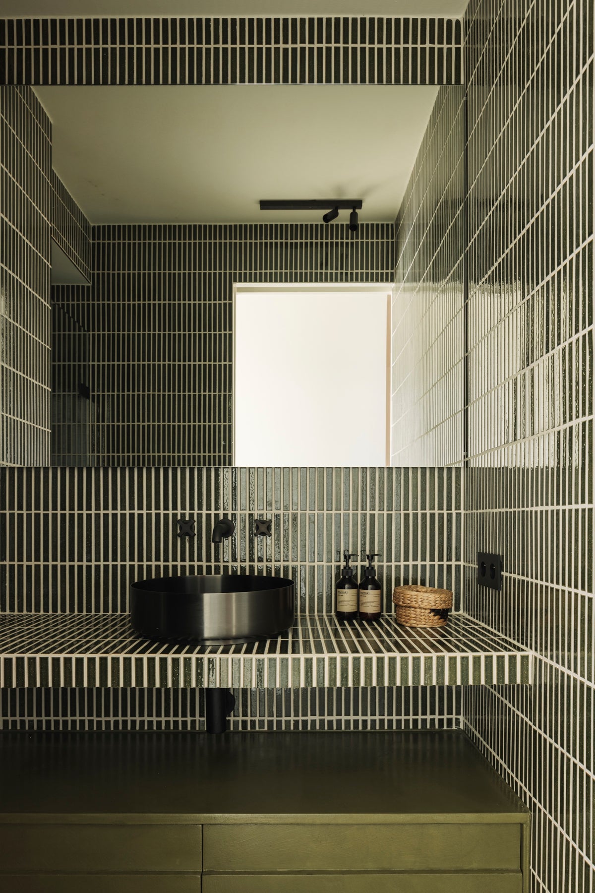 Kaji Border Vintage Green tiles with olive cabinetry in the penthouse bathroom