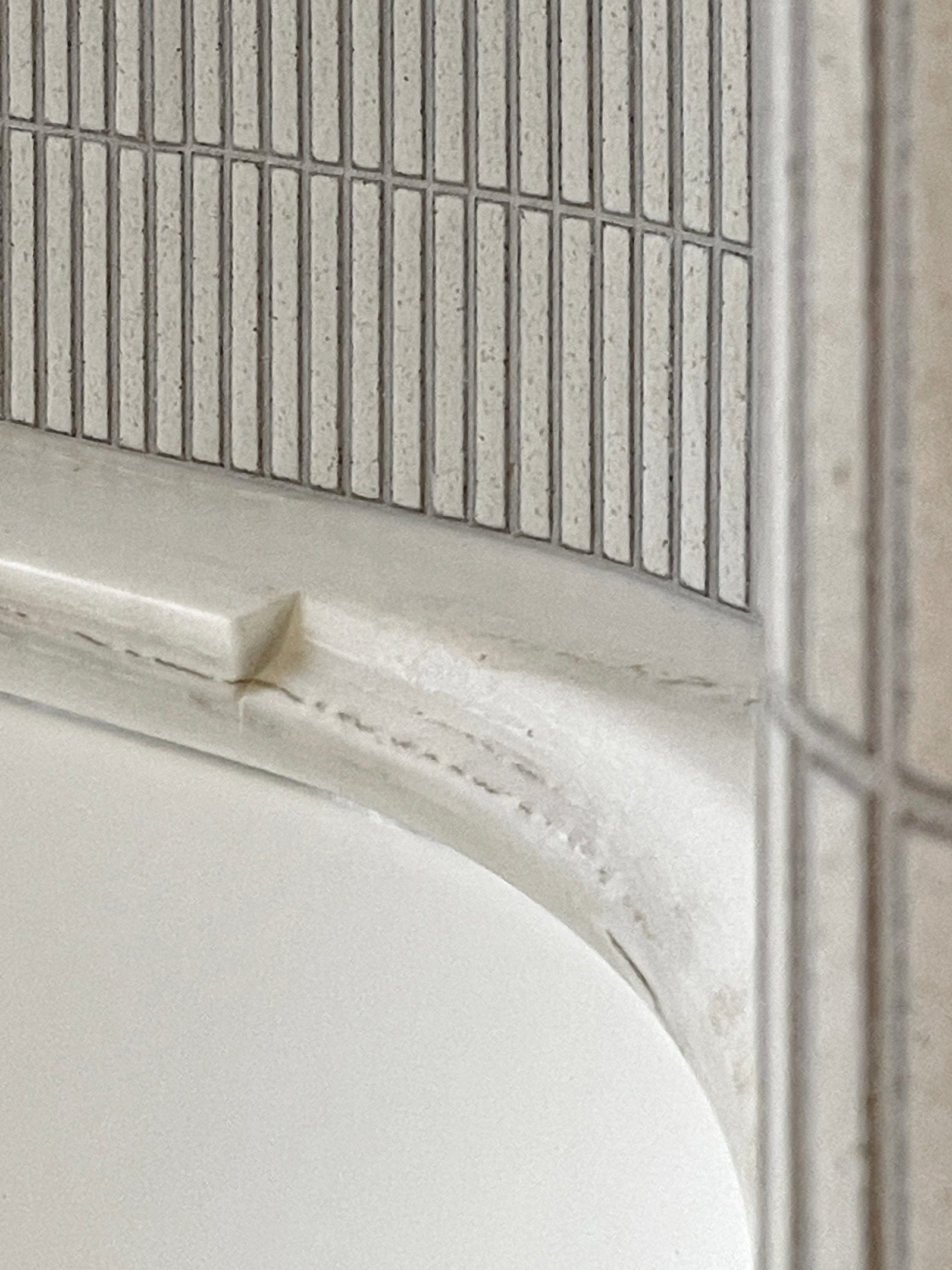 Precise junction between pale stone and Yohen Speckled White Japanese tile.