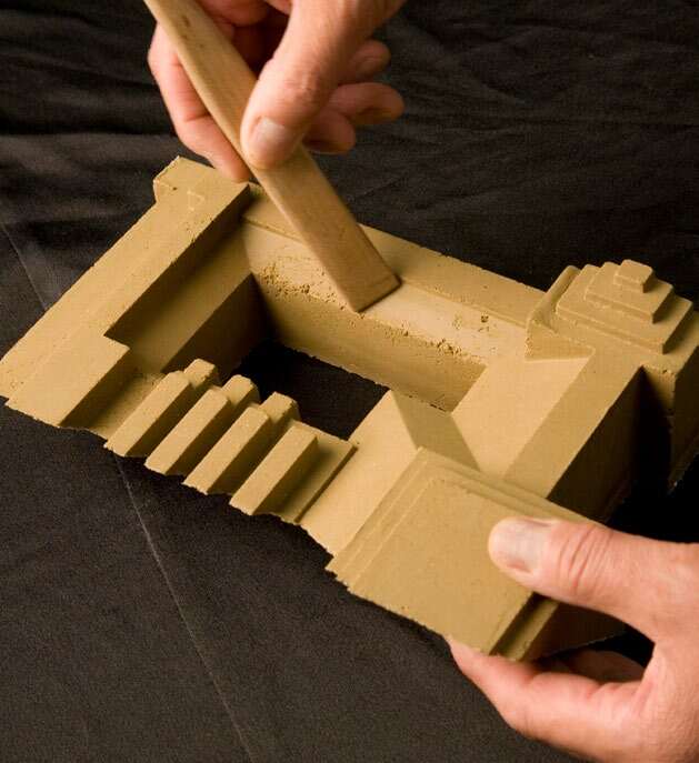 Hands working with a shaped Japanese tile